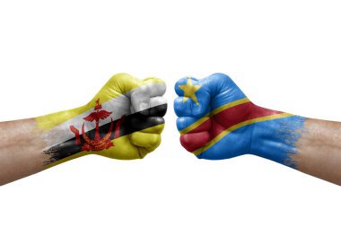 Two hands punch to each others on white background. Country flags painted fists, conflict crisis concept between brunei and dr congo