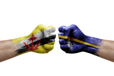 Two hands punch to each others on white background. Country flags painted fists, conflict crisis concept between brunei and nauru
