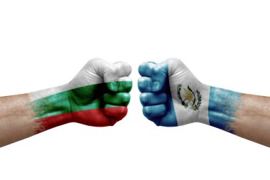 Two hands punch to each others on white background. Country flags painted fists, conflict crisis concept between bulgaria and guatemala