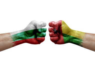 Two hands punch to each others on white background. Country flags painted fists, conflict crisis concept between bulgaria and guinea-bissau