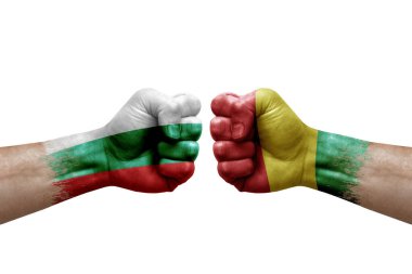 Two hands punch to each others on white background. Country flags painted fists, conflict crisis concept between bulgaria and guinea