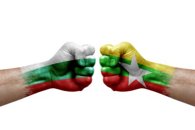 Two hands punch to each others on white background. Country flags painted fists, conflict crisis concept between bulgaria and myanmar