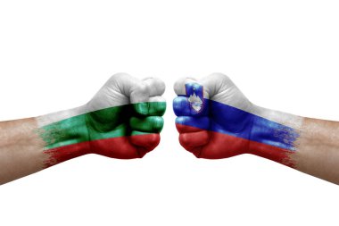 Two hands punch to each others on white background. Country flags painted fists, conflict crisis concept between bulgaria and slovenia