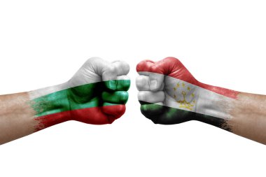 Two hands punch to each others on white background. Country flags painted fists, conflict crisis concept between bulgaria and tajikistan