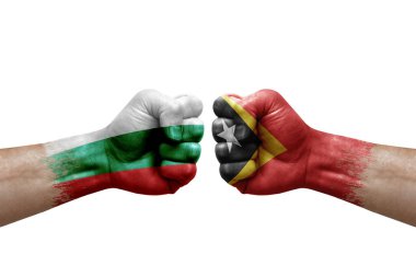 Two hands punch to each others on white background. Country flags painted fists, conflict crisis concept between bulgaria and timor leste