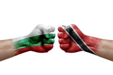 Two hands punch to each others on white background. Country flags painted fists, conflict crisis concept between bulgaria and tobago