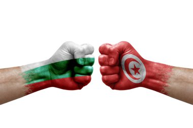 Two hands punch to each others on white background. Country flags painted fists, conflict crisis concept between bulgaria and tunisia