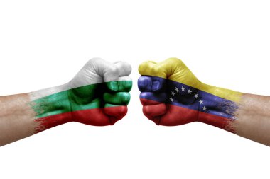 Two hands punch to each others on white background. Country flags painted fists, conflict crisis concept between bulgaria and venezuela