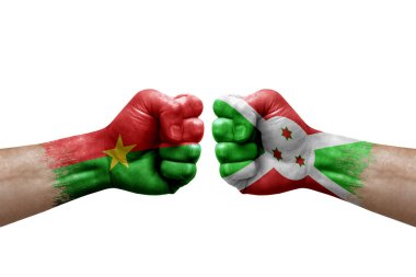 Two hands punch to each others on white background. Country flags painted fists, conflict crisis concept between burkina faso and burundi