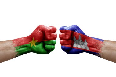Two hands punch to each others on white background. Country flags painted fists, conflict crisis concept between burkina faso and cambodia
