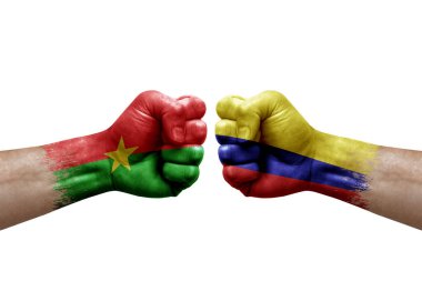Two hands punch to each others on white background. Country flags painted fists, conflict crisis concept between burkina faso and colombia