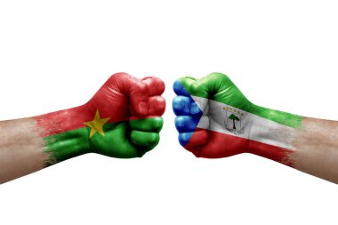 Two hands punch to each others on white background. Country flags painted fists, conflict crisis concept between burkina faso and equatorial guinea
