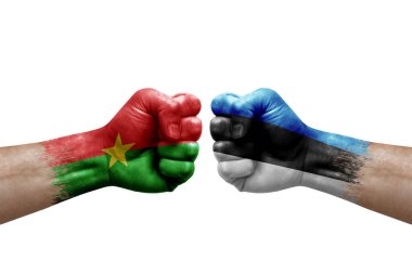 Two hands punch to each others on white background. Country flags painted fists, conflict crisis concept between burkina faso and estonia