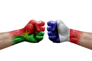 Two hands punch to each others on white background. Country flags painted fists, conflict crisis concept between burkina faso and france