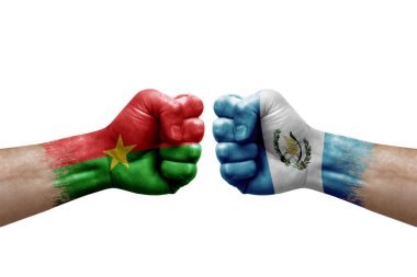 Two hands punch to each others on white background. Country flags painted fists, conflict crisis concept between burkina faso and guatemala
