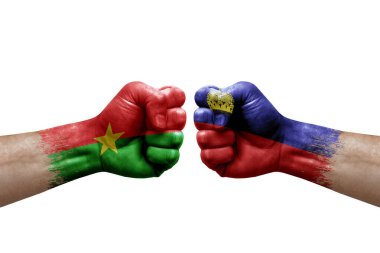 Two hands punch to each others on white background. Country flags painted fists, conflict crisis concept between burkina faso and liechtenstein