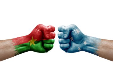 Two hands punch to each others on white background. Country flags painted fists, conflict crisis concept between burkina faso and micronesia