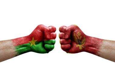 Two hands punch to each others on white background. Country flags painted fists, conflict crisis concept between burkina faso and montenegro