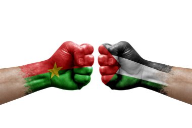 Two hands punch to each others on white background. Country flags painted fists, conflict crisis concept between burkina faso and palestine