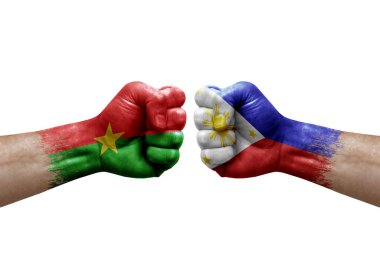 Two hands punch to each others on white background. Country flags painted fists, conflict crisis concept between burkina faso and philippines