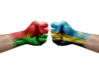 Two hands punch to each others on white background. Country flags painted fists, conflict crisis concept between burkina faso and rwanda