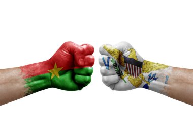 Two hands punch to each others on white background. Country flags painted fists, conflict crisis concept between burkina faso and virgin islands