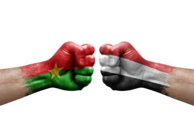 Two hands punch to each others on white background. Country flags painted fists, conflict crisis concept between burkina faso and yemen