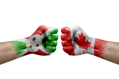 Two hands punch to each others on white background. Country flags painted fists, conflict crisis concept between burundi and canada