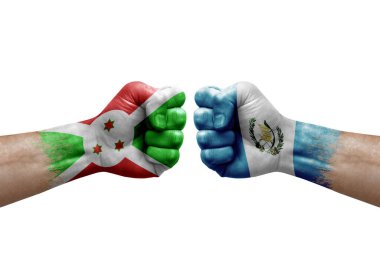 Two hands punch to each others on white background. Country flags painted fists, conflict crisis concept between burundi and guatemala