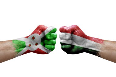 Two hands punch to each others on white background. Country flags painted fists, conflict crisis concept between burundi and hungary