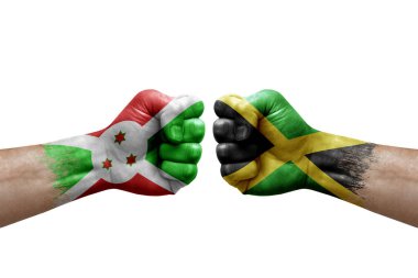Two hands punch to each others on white background. Country flags painted fists, conflict crisis concept between burundi and jamaica