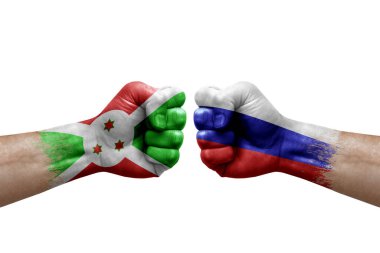 Two hands punch to each others on white background. Country flags painted fists, conflict crisis concept between burundi and russia