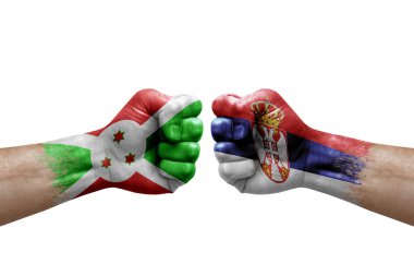 Two hands punch to each others on white background. Country flags painted fists, conflict crisis concept between burundi and serbia
