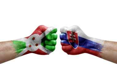 Two hands punch to each others on white background. Country flags painted fists, conflict crisis concept between burundi and slovakia
