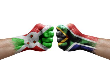 Two hands punch to each others on white background. Country flags painted fists, conflict crisis concept between burundi and south africa