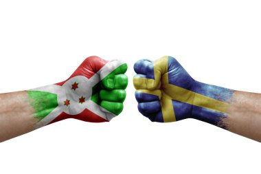 Two hands punch to each others on white background. Country flags painted fists, conflict crisis concept between burundi and sweden