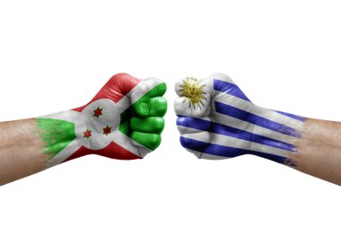 Two hands punch to each others on white background. Country flags painted fists, conflict crisis concept between burundi and uruguay