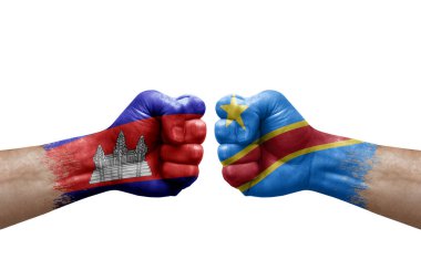 Two hands punch to each others on white background. Country flags painted fists, conflict crisis concept between cambodia and dr congo