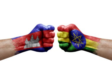 Two hands punch to each others on white background. Country flags painted fists, conflict crisis concept between cambodia and ethiopia