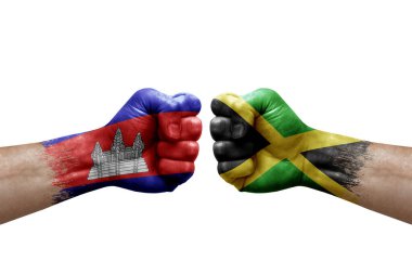 Two hands punch to each others on white background. Country flags painted fists, conflict crisis concept between cambodia and jamaica