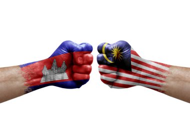 Two hands punch to each others on white background. Country flags painted fists, conflict crisis concept between cambodia and malaysia