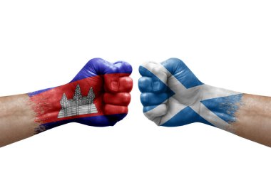 Two hands punch to each others on white background. Country flags painted fists, conflict crisis concept between cambodia and scotland