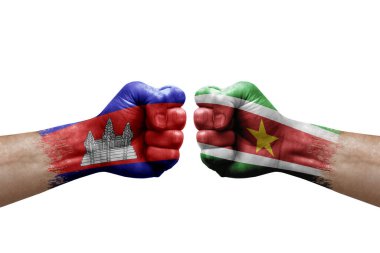 Two hands punch to each others on white background. Country flags painted fists, conflict crisis concept between cambodia and suriname
