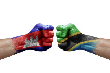 Two hands punch to each others on white background. Country flags painted fists, conflict crisis concept between cambodia and tanzania