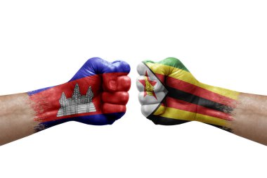 Two hands punch to each others on white background. Country flags painted fists, conflict crisis concept between cambodia and zimbabwe