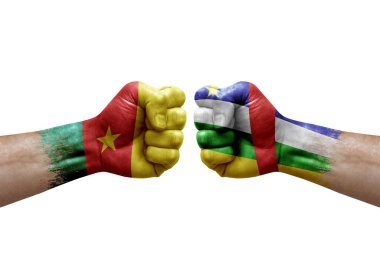 Two hands punch to each others on white background. Country flags painted fists, conflict crisis concept between cameroon and central african republic