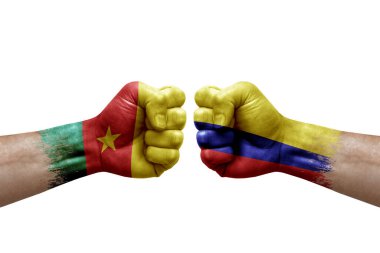Two hands punch to each others on white background. Country flags painted fists, conflict crisis concept between cameroon and colombia