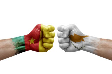 Two hands punch to each others on white background. Country flags painted fists, conflict crisis concept between cameroon and cyprus