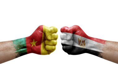 Two hands punch to each others on white background. Country flags painted fists, conflict crisis concept between cameroon and egypt