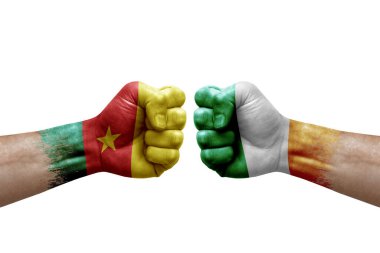 Two hands punch to each others on white background. Country flags painted fists, conflict crisis concept between cameroon and ireland